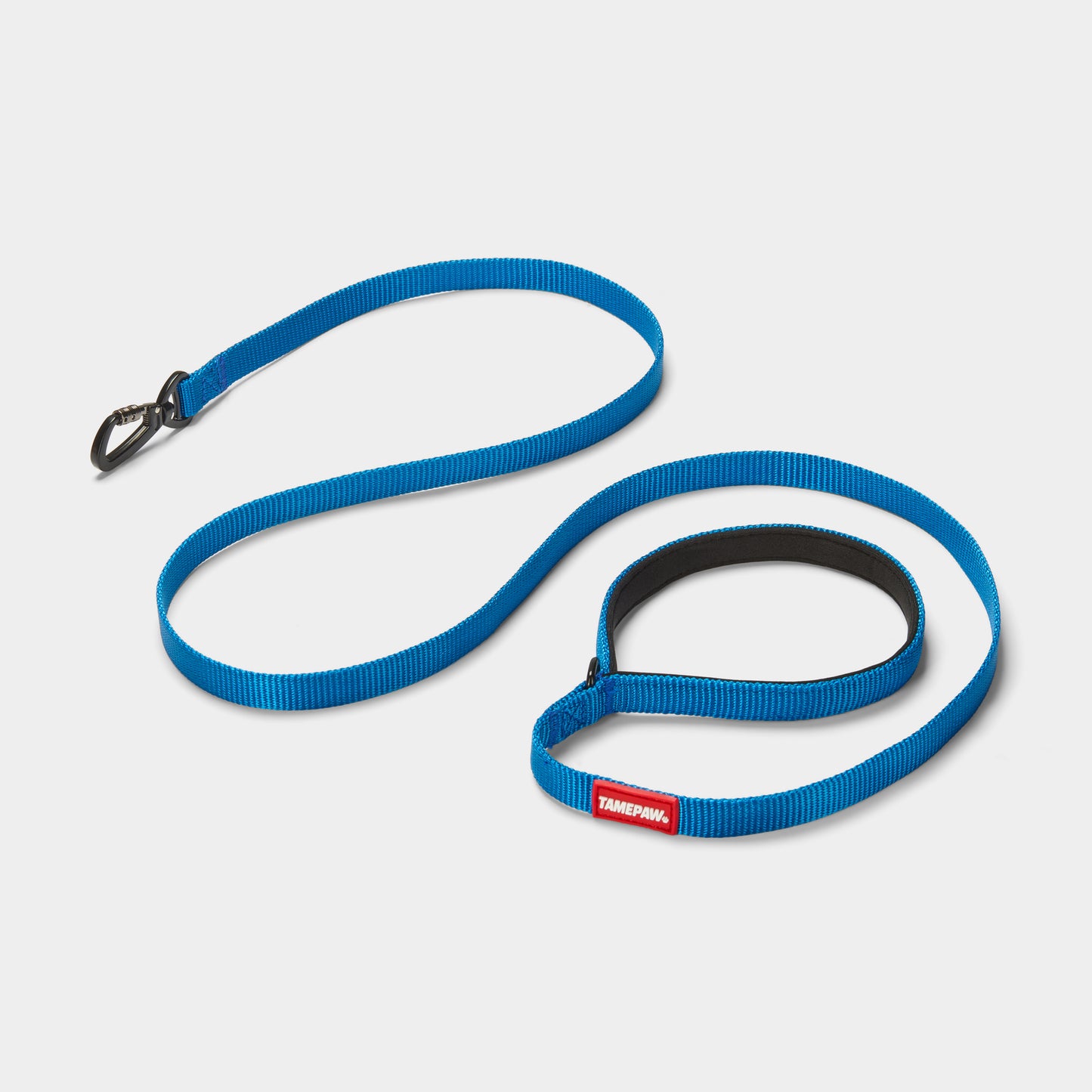 Blue Tamepaw dog leash with a red and white label on a light grey background